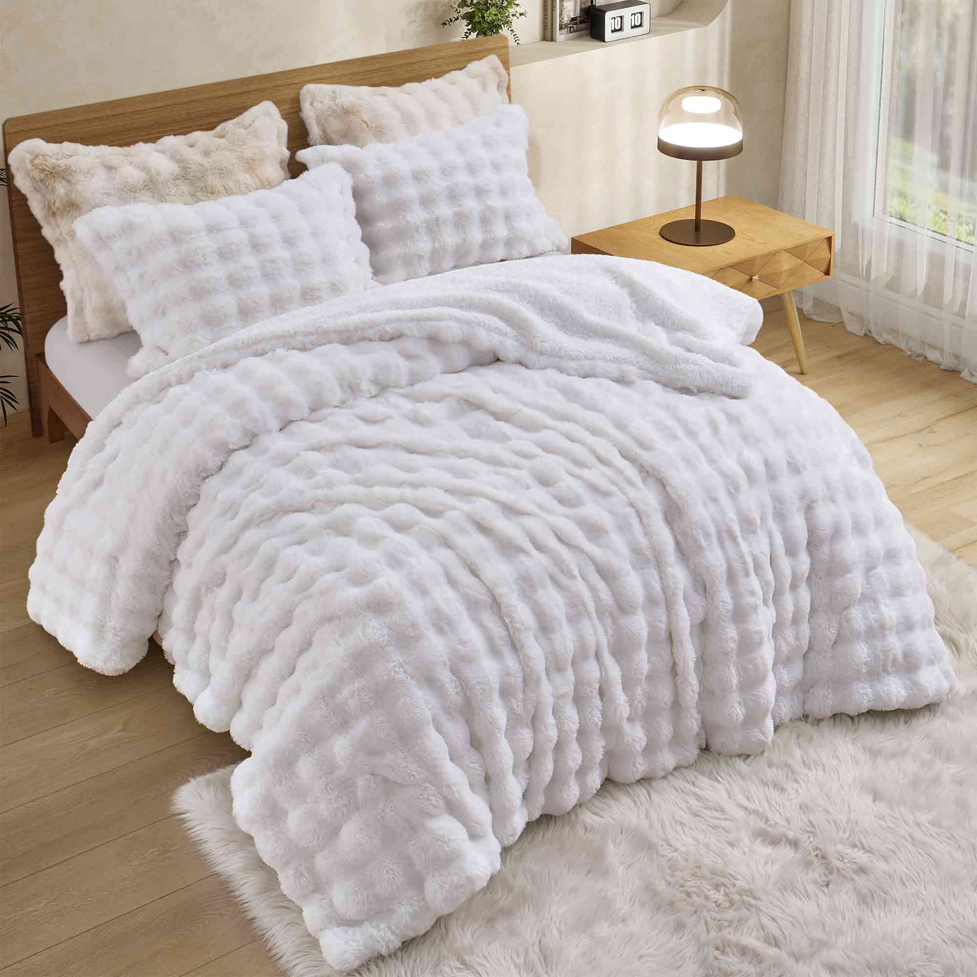 White faux rabbit fur comforter set with sherpa reverse and zip-closure pillow shams, creating a clean, timeless, and luxurious atmosphere.