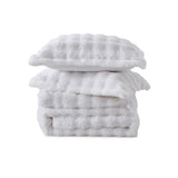 White faux rabbit fur comforter set with sherpa reverse and zip-closure pillow shams, creating a clean, timeless, and luxurious atmosphere.