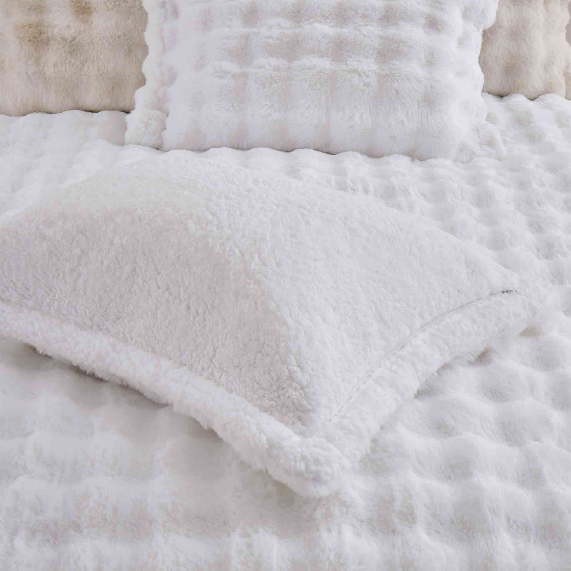 White faux rabbit fur comforter set with sherpa reverse and zip-closure pillow shams, creating a clean, timeless, and luxurious atmosphere.