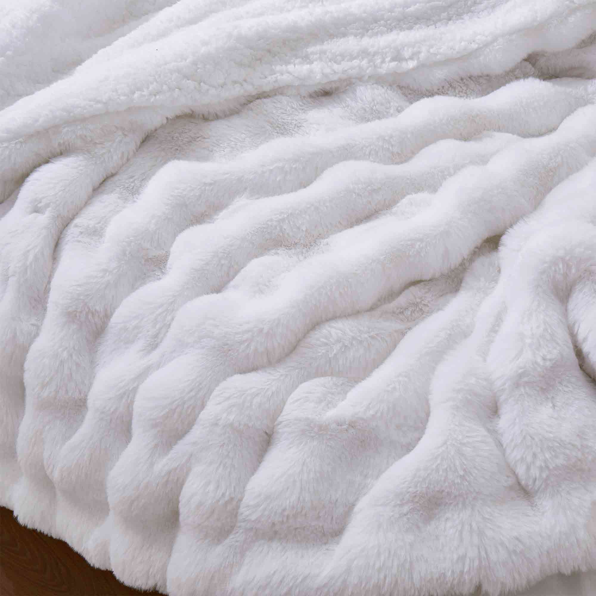 White faux rabbit fur comforter set with sherpa reverse and zip-closure pillow shams, creating a clean, timeless, and luxurious atmosphere.