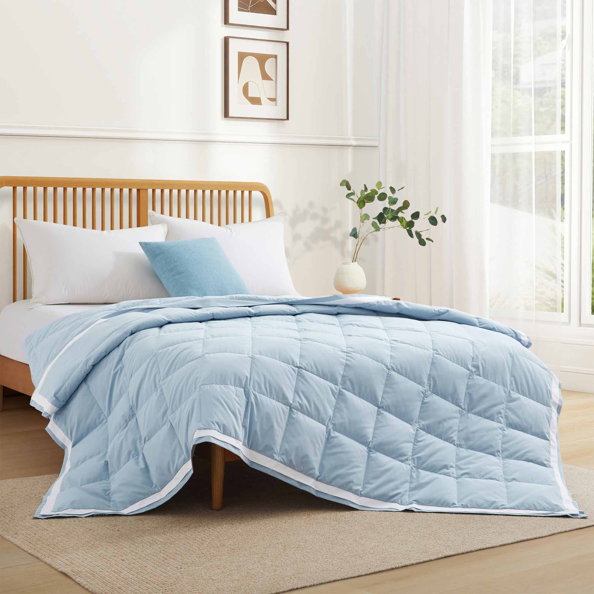 The feather down comforter blanket is enveloped in the airy tones of sky blue with a contrasting white trim. Enhance your bedding with the beauty of the skies with this summer season comforter in sky blue.