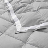 The summer cooling blanket is covered in the somber hues of gray with a complementing white trim. Bring refreshing sophistication to your personal space with this down duvet insert in gray.