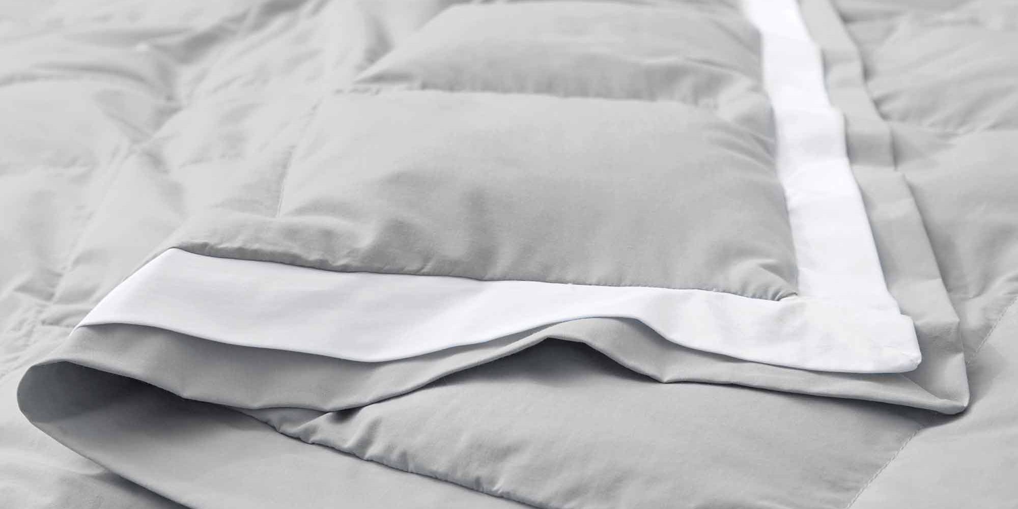 The summer cooling blanket is covered in the somber hues of gray with a complementing white trim. Bring refreshing sophistication to your personal space with this down duvet insert in gray.