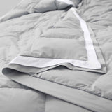 The summer cooling blanket is covered in the somber hues of gray with a complementing white trim. Bring refreshing sophistication to your personal space with this down duvet insert in gray.