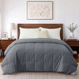 Modern bedroom featuring a wooden bed dressed in the Woven Stripe Down Blanket, complemented by two nightstands and botanical artwork on the wall.