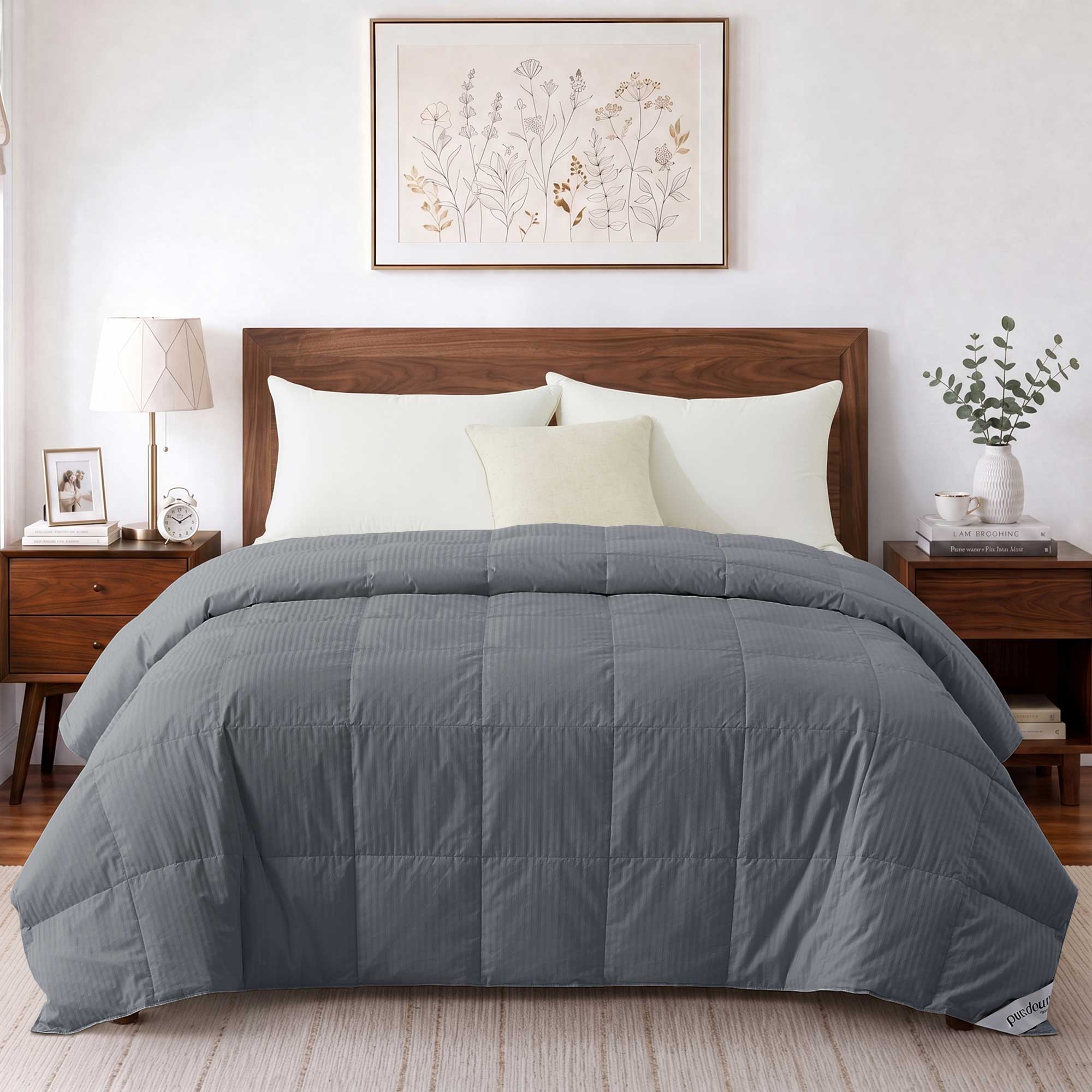 Modern bedroom featuring a wooden bed dressed in the Woven Stripe Down Blanket, complemented by two nightstands and botanical artwork on the wall.