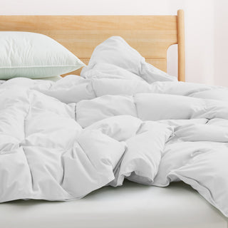 Fresh white tones are brushed over the all-size comforter. Add a touch of all-around luxurious warmth to your modern bedroom design with this down comforter with feathers.
