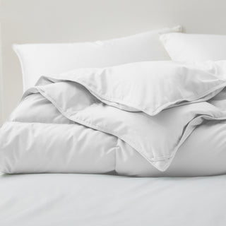 Fresh white tones are brushed over the all-size comforter. Add a touch of all-around luxurious warmth to your modern bedroom design with this down comforter with feathers.