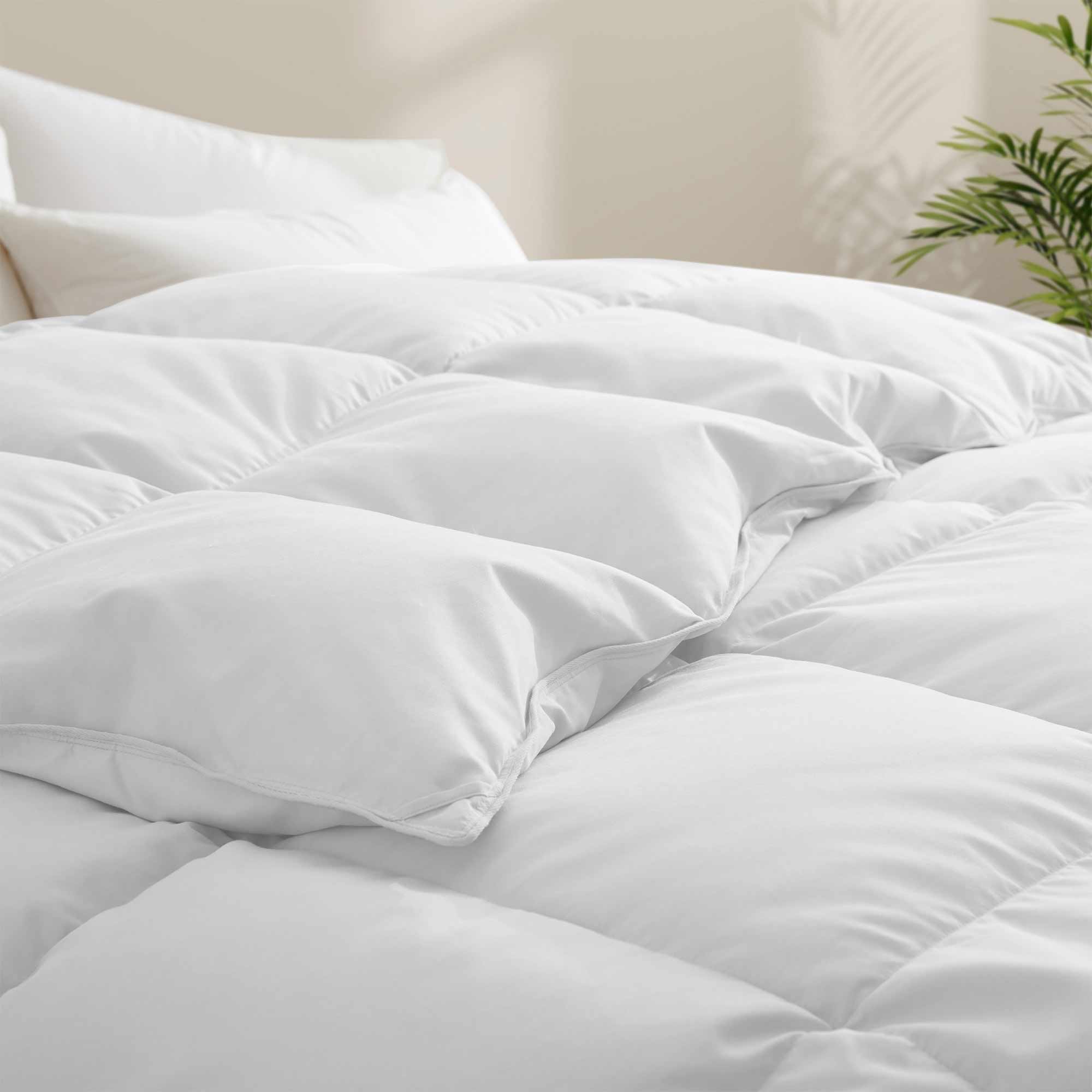 Fresh white tones are brushed over the all-size comforter. Add a touch of all-around luxurious warmth to your modern bedroom design with this down comforter with feathers.