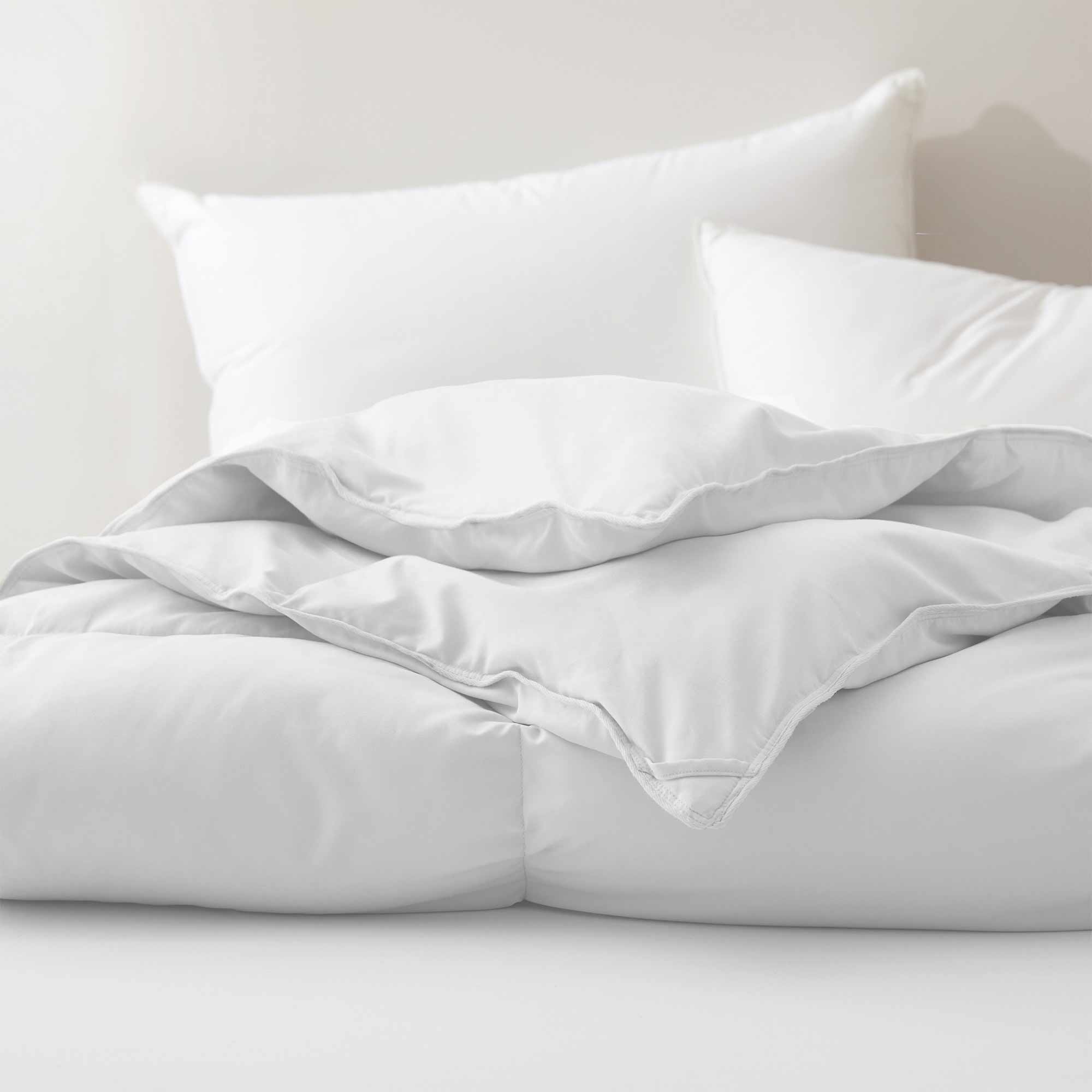 Fresh white tones are brushed over the all-size comforter. Add a touch of all-around luxurious warmth to your modern bedroom design with this down comforter with feathers.