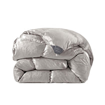 The comforter is covered in a brilliant silvery-gray shade and features soft damask patterns throughout that add a touch of texture to the fabric. Bring home the beauty of sophistication with this silk comforter.