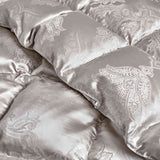 The comforter is covered in a brilliant silvery-gray shade and features soft damask patterns throughout that add a touch of texture to the fabric. Bring home the beauty of sophistication with this silk comforter.