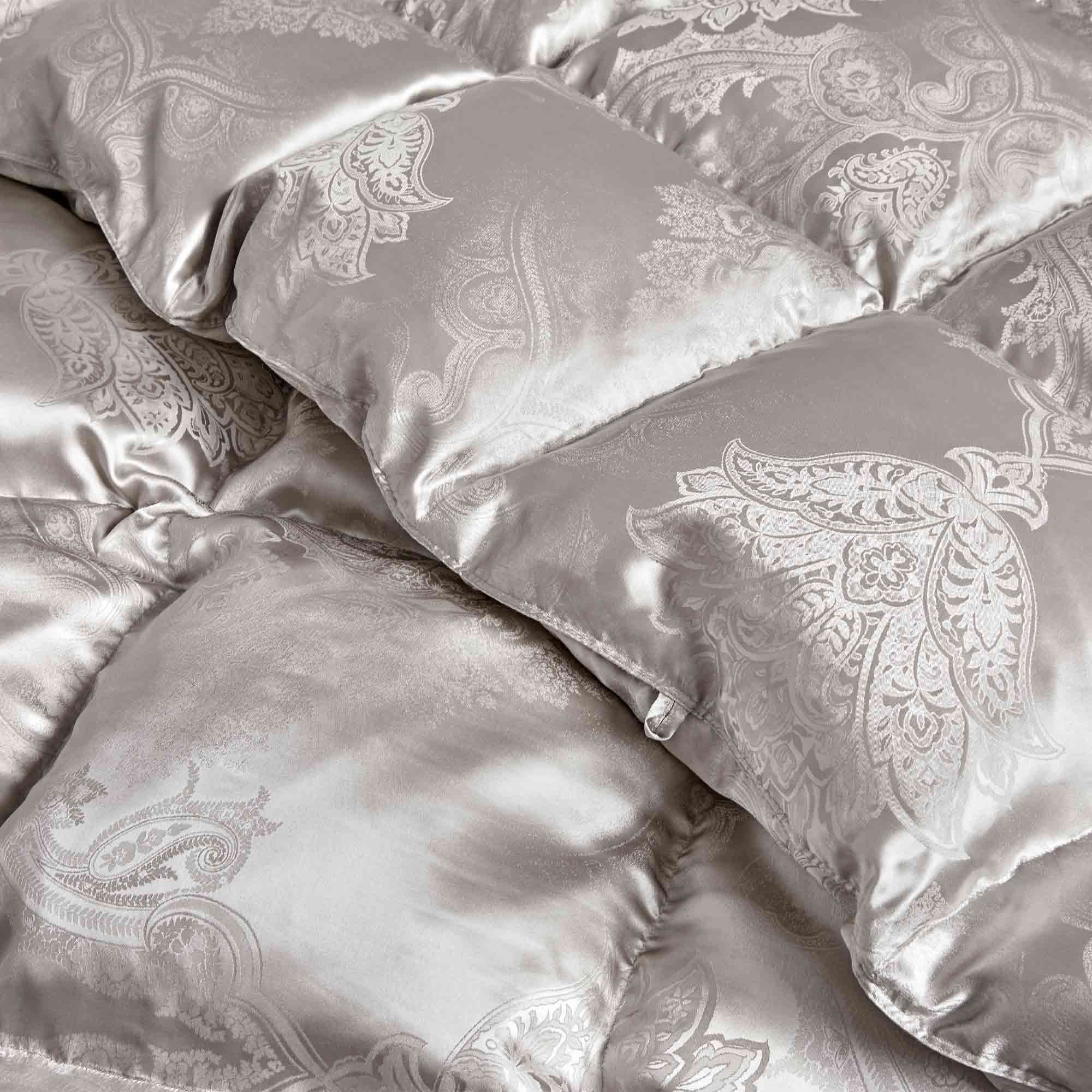 The comforter is covered in a brilliant silvery-gray shade and features soft damask patterns throughout that add a touch of texture to the fabric. Bring home the beauty of sophistication with this silk comforter.