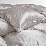 The comforter is covered in a brilliant silvery-gray shade and features soft damask patterns throughout that add a touch of texture to the fabric. Bring home the beauty of sophistication with this silk comforter.