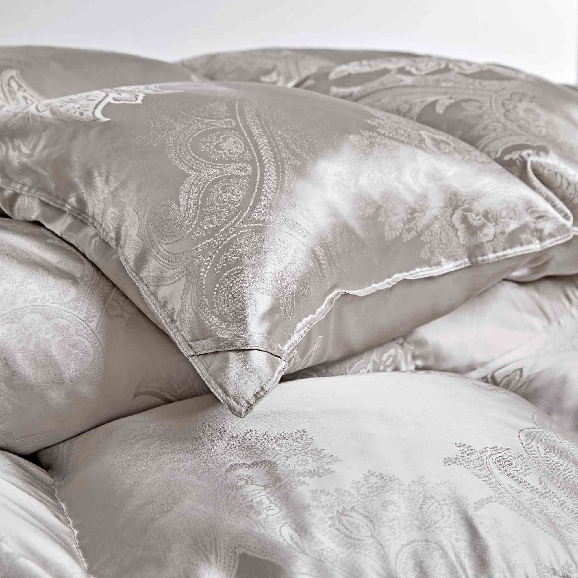 The comforter is covered in a brilliant silvery-gray shade and features soft damask patterns throughout that add a touch of texture to the fabric. Bring home the beauty of sophistication with this silk comforter.