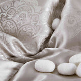 The comforter is covered in a brilliant silvery-gray shade and features soft damask patterns throughout that add a touch of texture to the fabric. Bring home the beauty of sophistication with this silk comforter.