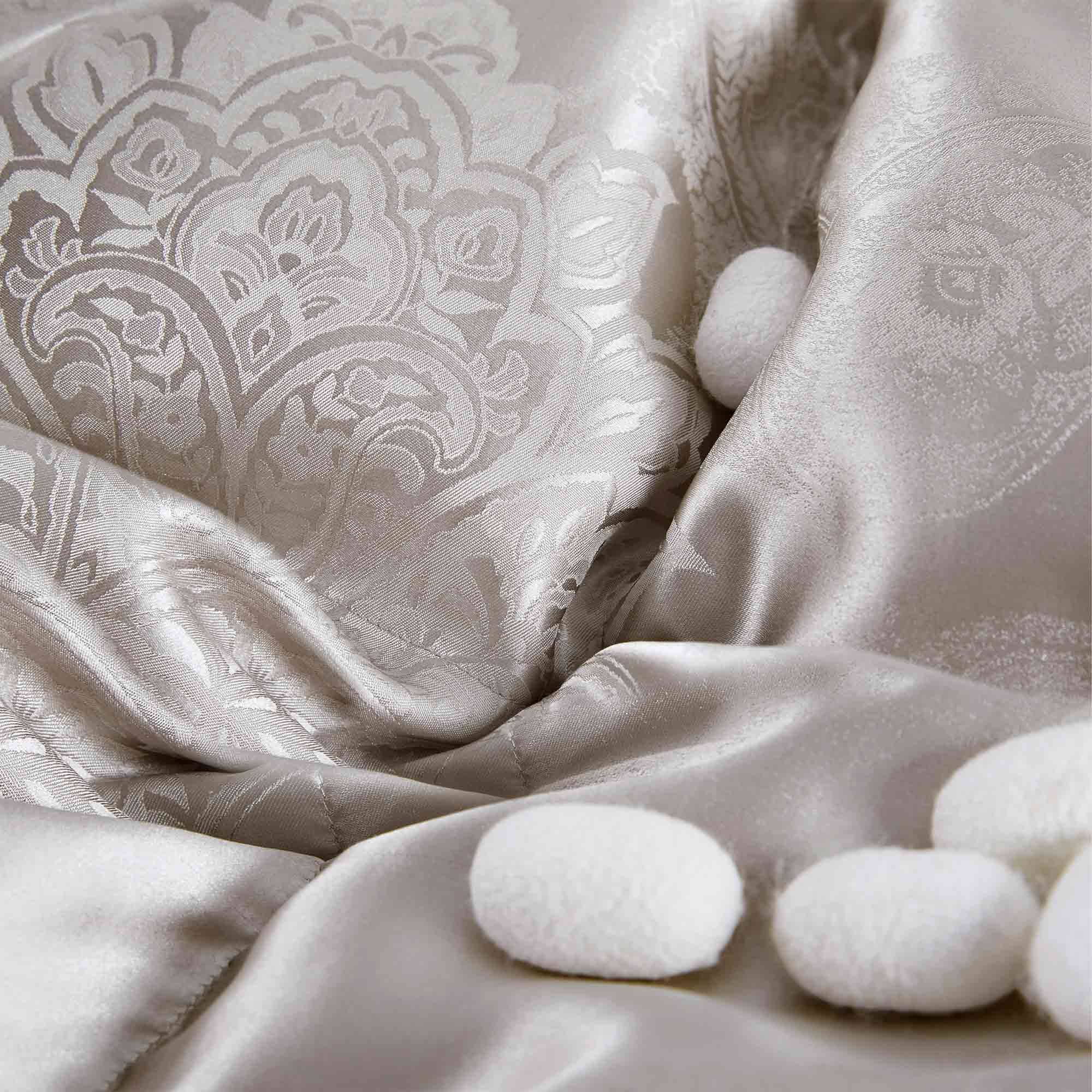 The comforter is covered in a brilliant silvery-gray shade and features soft damask patterns throughout that add a touch of texture to the fabric. Bring home the beauty of sophistication with this silk comforter.