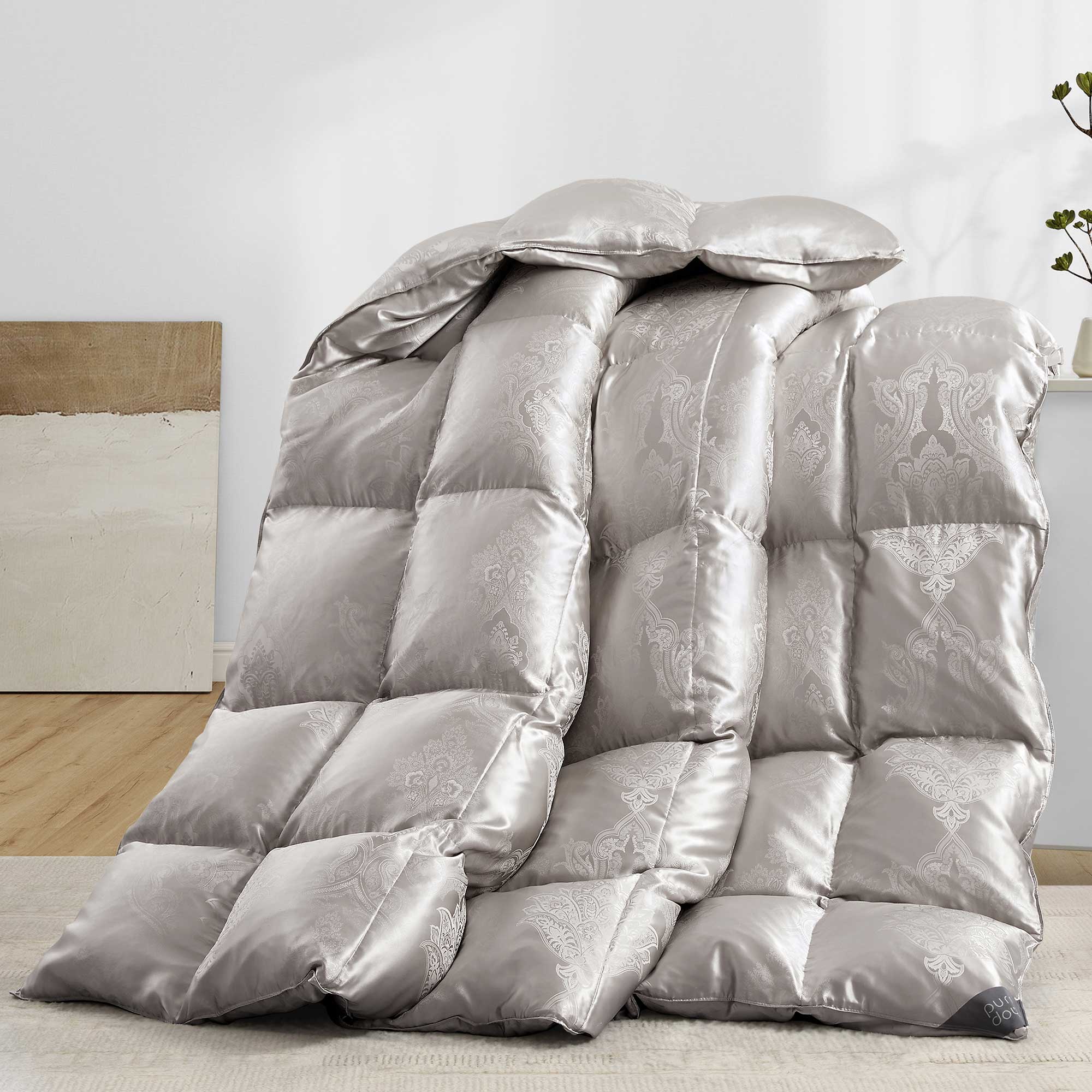 The comforter is covered in a brilliant silvery-gray shade and features soft damask patterns throughout that add a touch of texture to the fabric. Bring home the beauty of sophistication with this silk comforter.