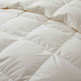 Crafted with a 100% organic cotton shell and filled with 90% natural white down, this comforter offers superior warmth and breathability. Its 800 fill power ensures a lightweight yet insulating sleep experience. Designed for year-round comfort, it features baffle box construction to maintain even fill distribution. Available in all-season and extra warm options, this comforter combines eco-friendly materials with luxurious softness for a restful night's sleep.
