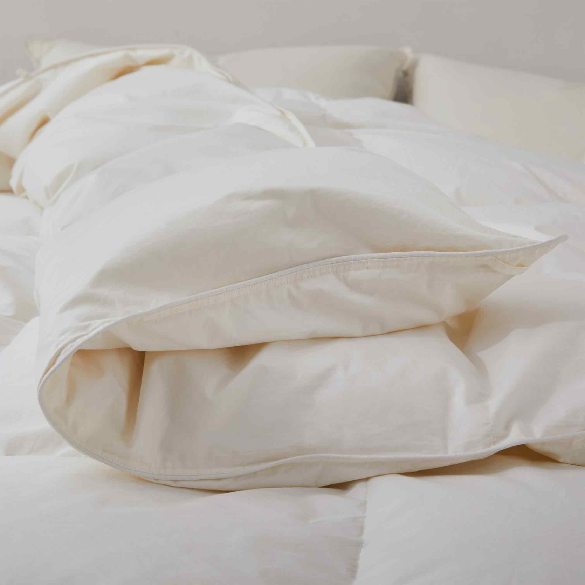 Crafted with a 100% organic cotton shell and filled with 90% natural white down, this comforter offers superior warmth and breathability. Its 800 fill power ensures a lightweight yet insulating sleep experience. Designed for year-round comfort, it features baffle box construction to maintain even fill distribution. Available in all-season and extra warm options, this comforter combines eco-friendly materials with luxurious softness for a restful night's sleep.