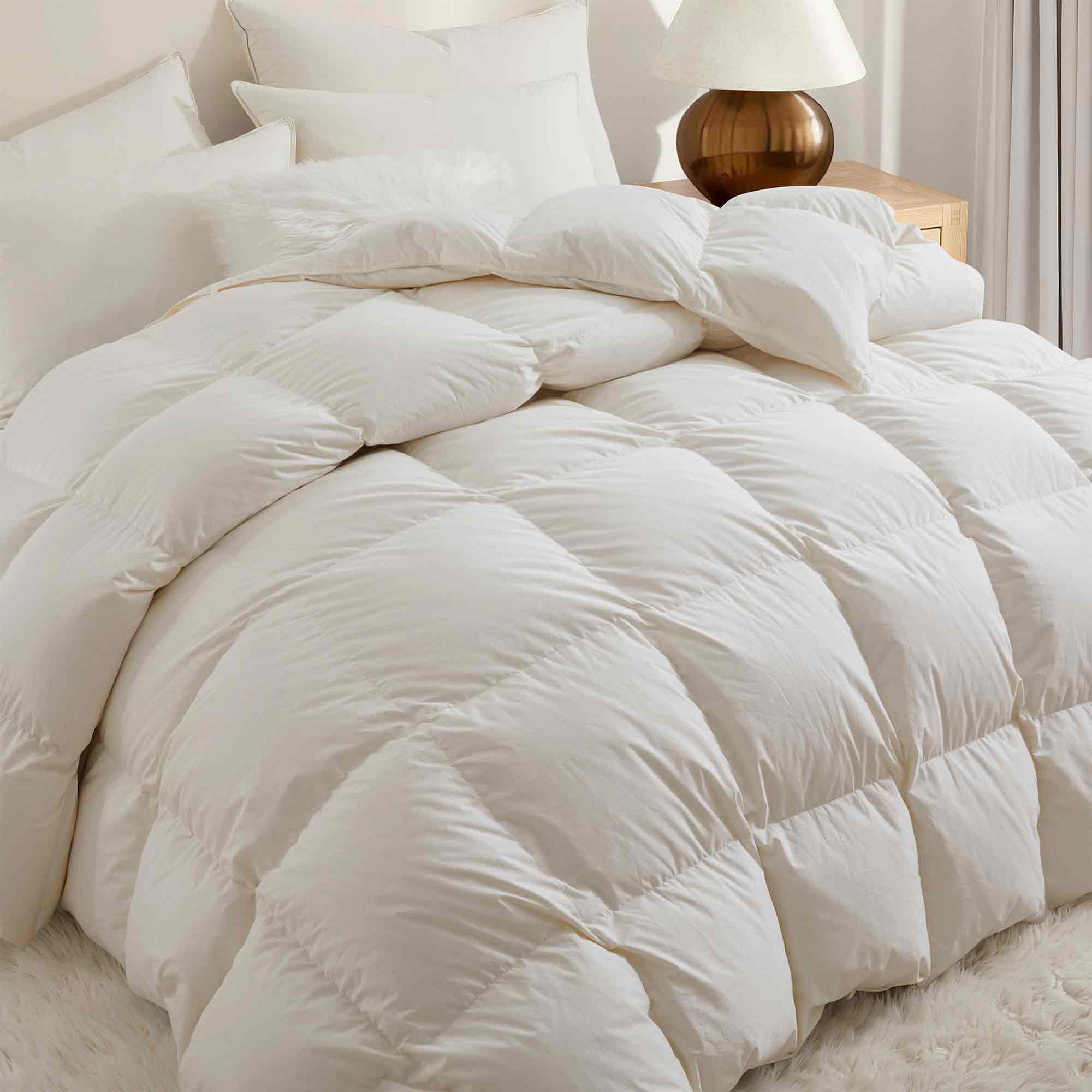 Crafted with a 100% organic cotton shell and filled with 90% natural white down, this comforter offers superior warmth and breathability. Its 800 fill power ensures a lightweight yet insulating sleep experience. Designed for year-round comfort, it features baffle box construction to maintain even fill distribution. Available in all-season and extra warm options, this comforter combines eco-friendly materials with luxurious softness for a restful night's sleep.