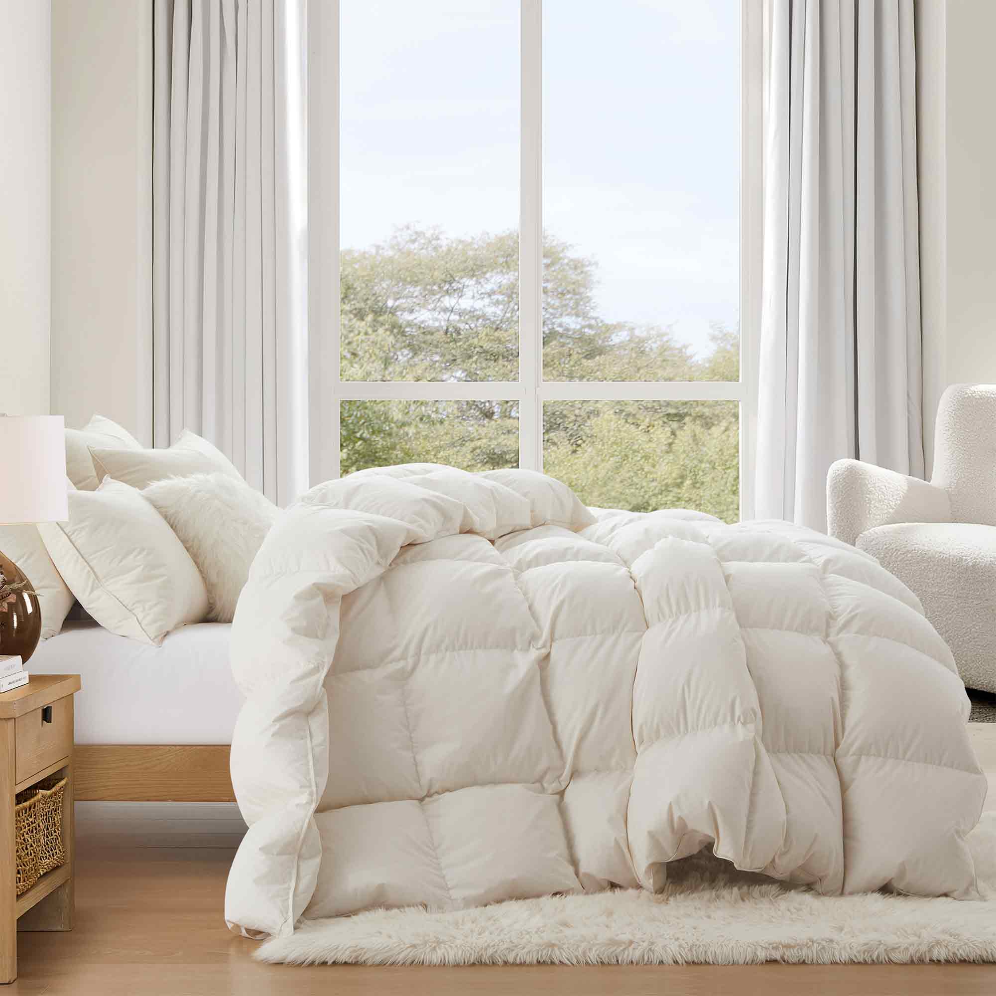 Crafted with a 100% organic cotton shell and filled with 90% natural white down, this comforter offers superior warmth and breathability. Its 800 fill power ensures a lightweight yet insulating sleep experience. Designed for year-round comfort, it features baffle box construction to maintain even fill distribution. Available in all-season and extra warm options, this comforter combines eco-friendly materials with luxurious softness for a restful night's sleep.
