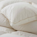 Crafted with a 100% organic cotton shell and filled with 90% natural white down, this comforter offers superior warmth and breathability. Its 800 fill power ensures a lightweight yet insulating sleep experience. Designed for year-round comfort, it features baffle box construction to maintain even fill distribution. Available in all-season and extra warm options, this comforter combines eco-friendly materials with luxurious softness for a restful night's sleep.