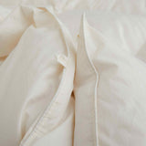 Crafted with a 100% organic cotton shell and filled with 90% natural white down, this comforter offers superior warmth and breathability. Its 800 fill power ensures a lightweight yet insulating sleep experience. Designed for year-round comfort, it features baffle box construction to maintain even fill distribution. Available in all-season and extra warm options, this comforter combines eco-friendly materials with luxurious softness for a restful night's sleep.
