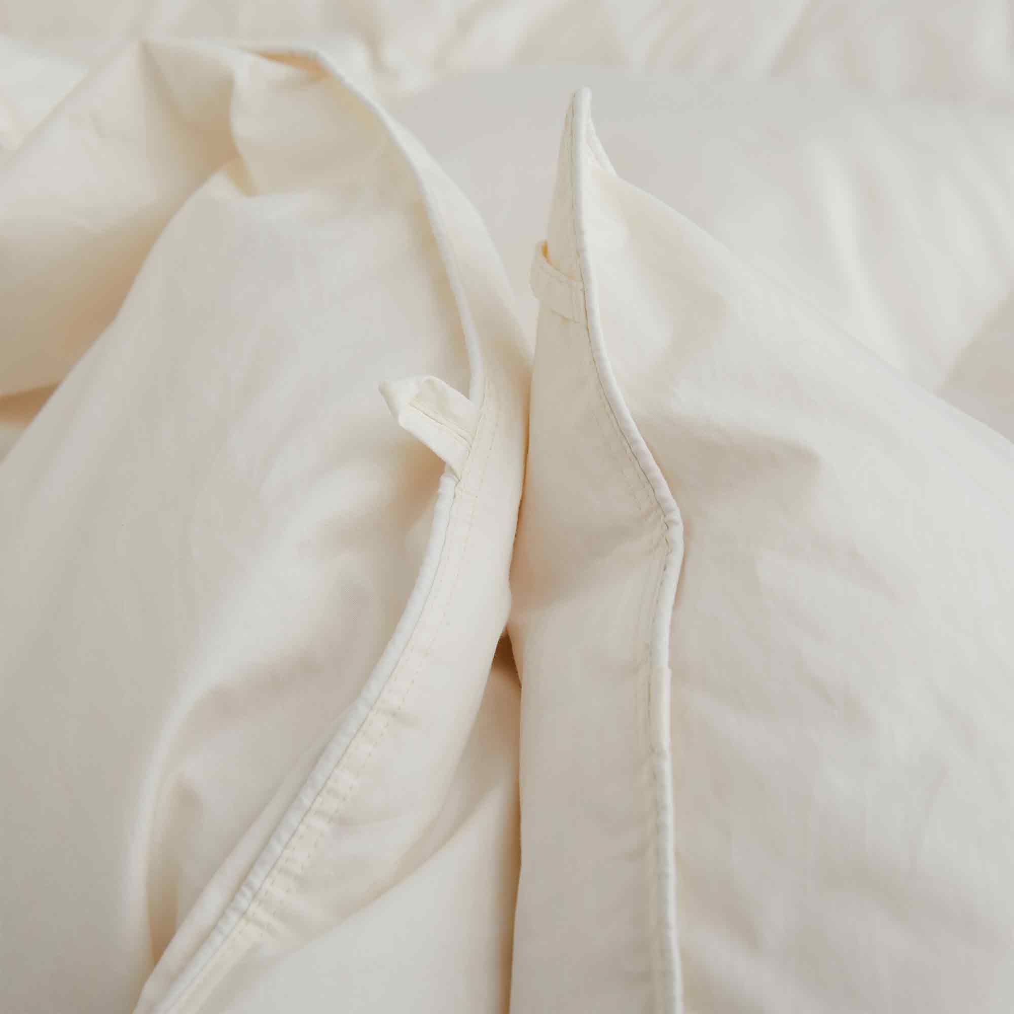 Crafted with a 100% organic cotton shell and filled with 90% natural white down, this comforter offers superior warmth and breathability. Its 800 fill power ensures a lightweight yet insulating sleep experience. Designed for year-round comfort, it features baffle box construction to maintain even fill distribution. Available in all-season and extra warm options, this comforter combines eco-friendly materials with luxurious softness for a restful night's sleep.