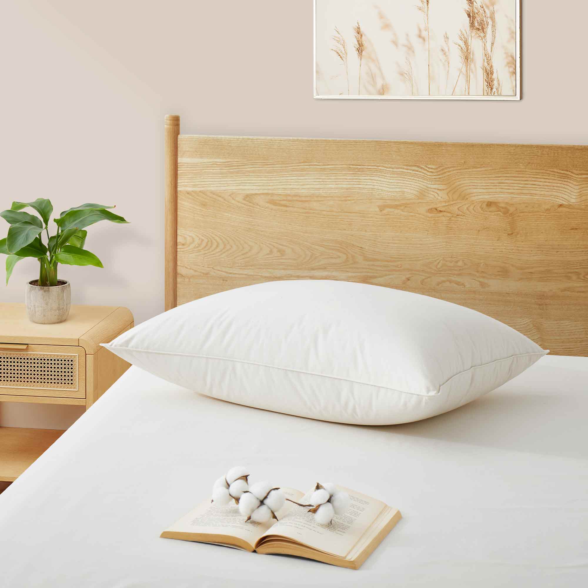The fluffier pillow is covered in soft hues of off-white. Sink in the plush support and comfort of these best down pillows.