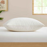 The fluffier pillow is covered in soft hues of off-white. Sink in the plush support and comfort of these best down pillows.