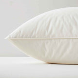 The fluffier pillow is covered in soft hues of off-white. Sink in the plush support and comfort of these best down pillows.