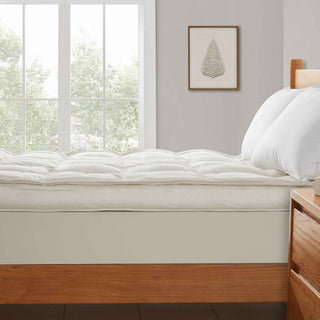 The plush surface of this feather blend mattress down topper is colored in pearly hues of off-white. Adding this feather mattress topper to your bedroom is an excellent choice for deep cushioning and additional comfort layer for a healthy sleep environment.