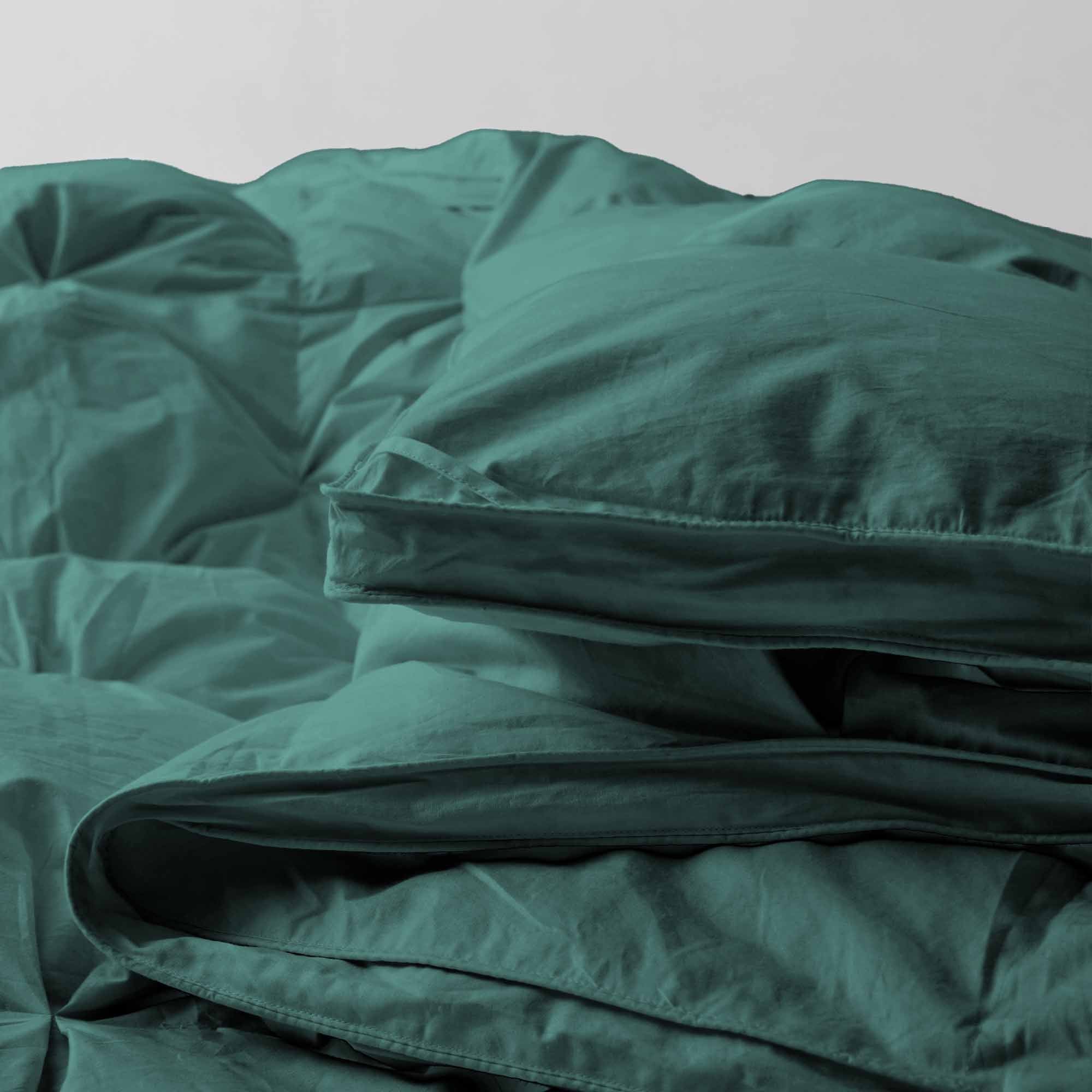 The down feather comforter is brushed in medium tones of forest green. Add a natural element to your bedroom style with this green color medium weight comforter.