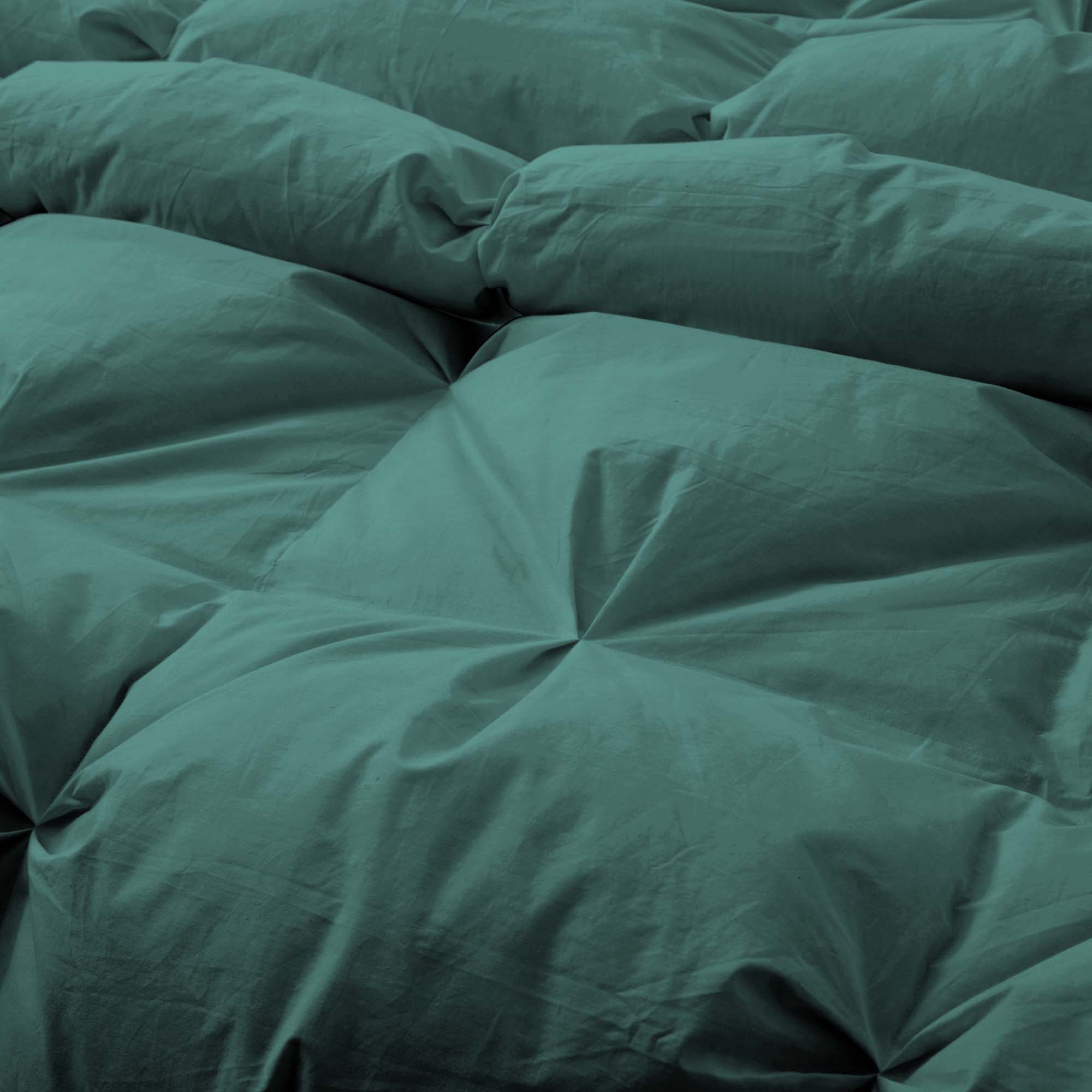 The down feather comforter is brushed in medium tones of forest green. Add a natural element to your bedroom style with this green color medium weight comforter.