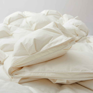 The down goose feather comforter is brushed in the pearly tones of off-white. Bring sophisticated elegance to your bedroom decor with this off-white bed comforter.