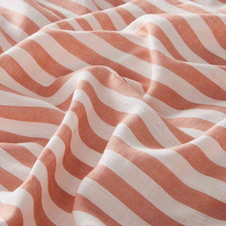 The designer bedding set is covered in alternating white and coral stripes. Elevate your bedroom decor with our duvet cover set featuring vibrant coral stripes for a bold and stylish statement.