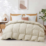 A neatly made bed featuring the Premium Goose Feather Comforter in beige, complemented by white pillows and wooden furniture in a cozy bedroom.