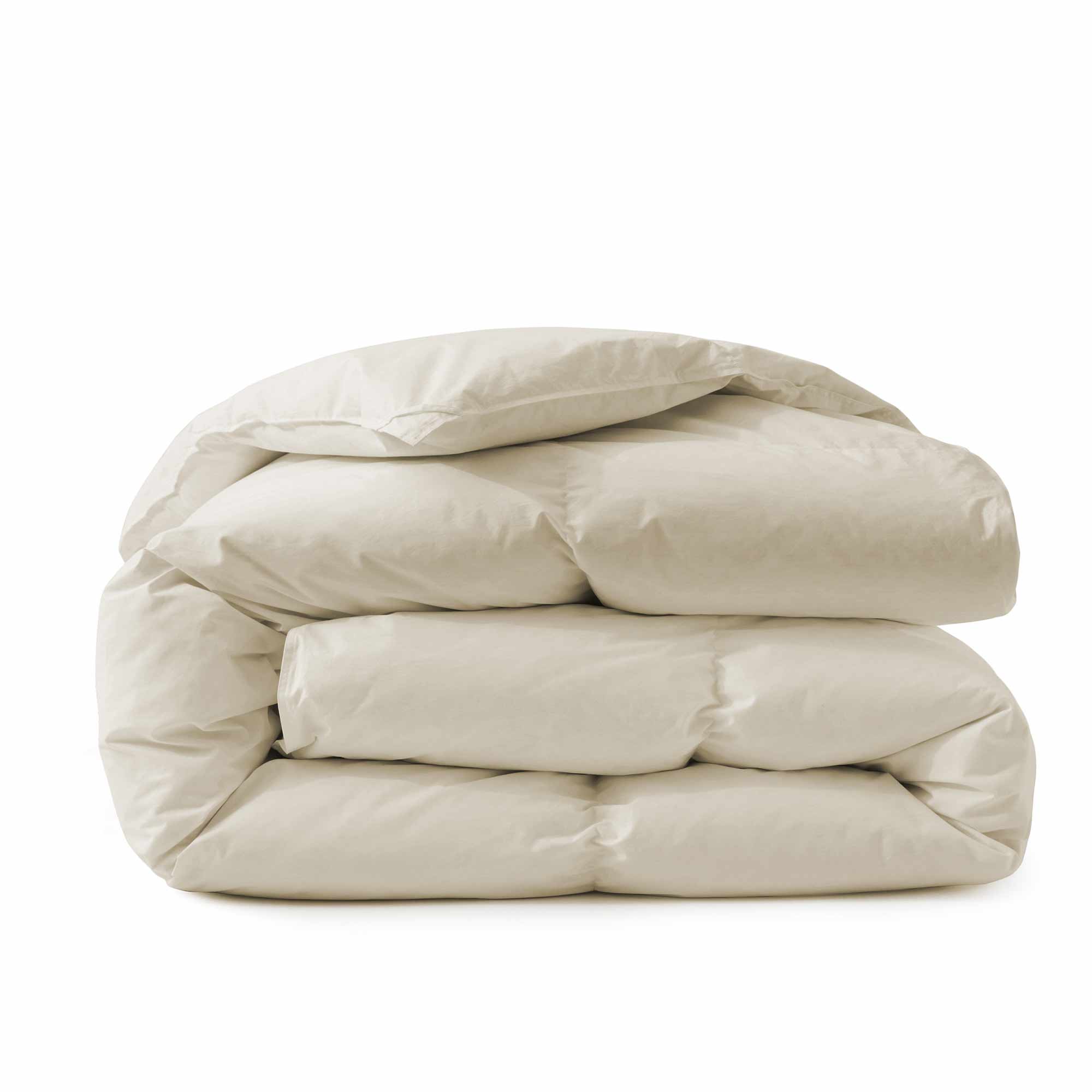 A Premium Goose Feather Comforter, elegantly folded in a cream hue, is stacked neatly on a white surface.