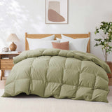 A neatly made bed featuring the Premium Goose Feather Comforter in green, complemented by white pillows, a nightstand, and modern wall art above.