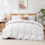 A neatly made bed featuring the Premium Goose Feather Comforter in white bedding, paired with a wood headboard, nightstand, lamp, plant, and abstract wall art.