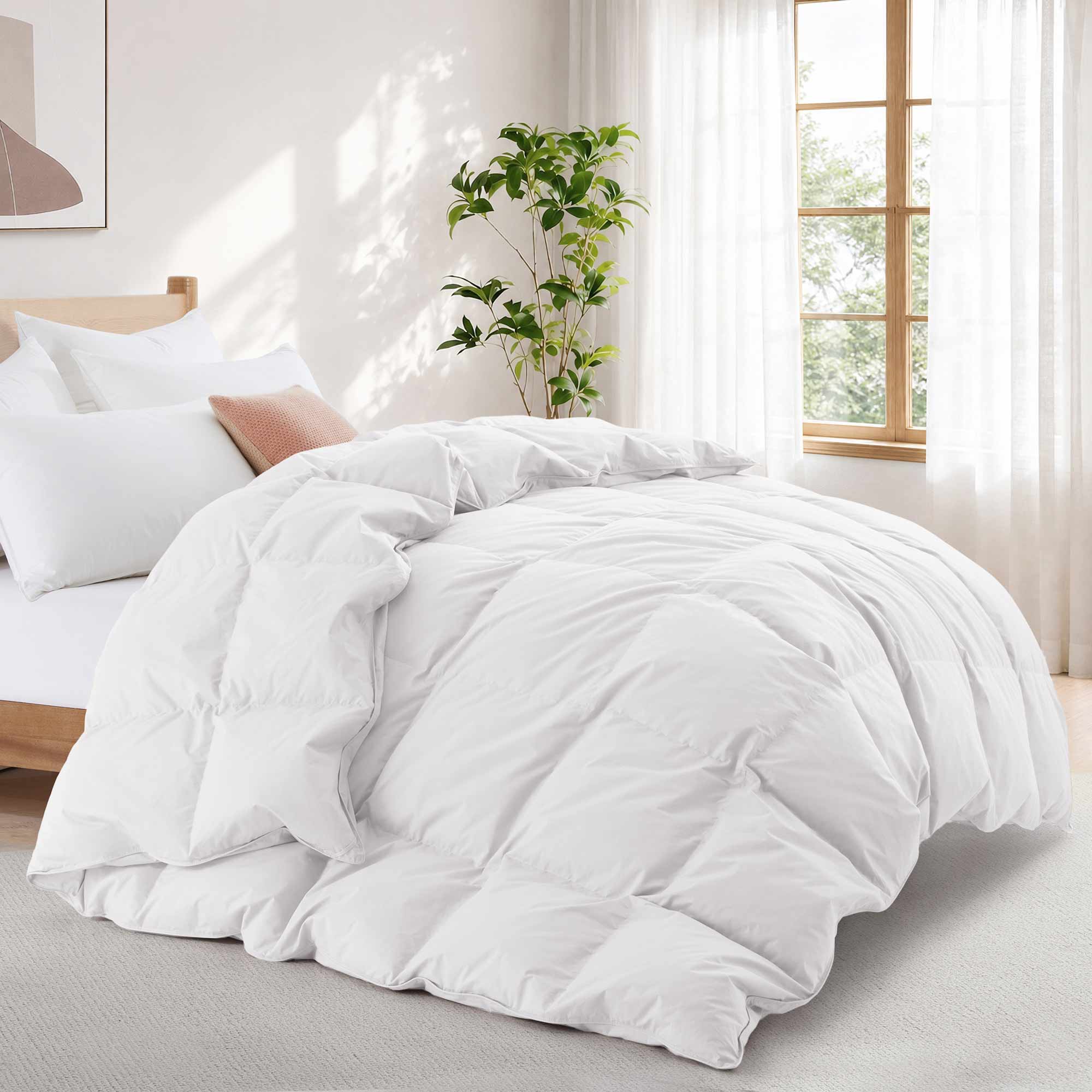 A Premium Goose Feather Comforter adds a cozy, fluffy touch to a bed in a bright, sunlit bedroom with a plant and window.