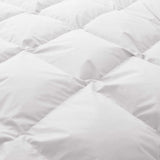 Close-up of the Premium Goose Feather Comforter, featuring a white, quilted design and a soft, puffy texture.
