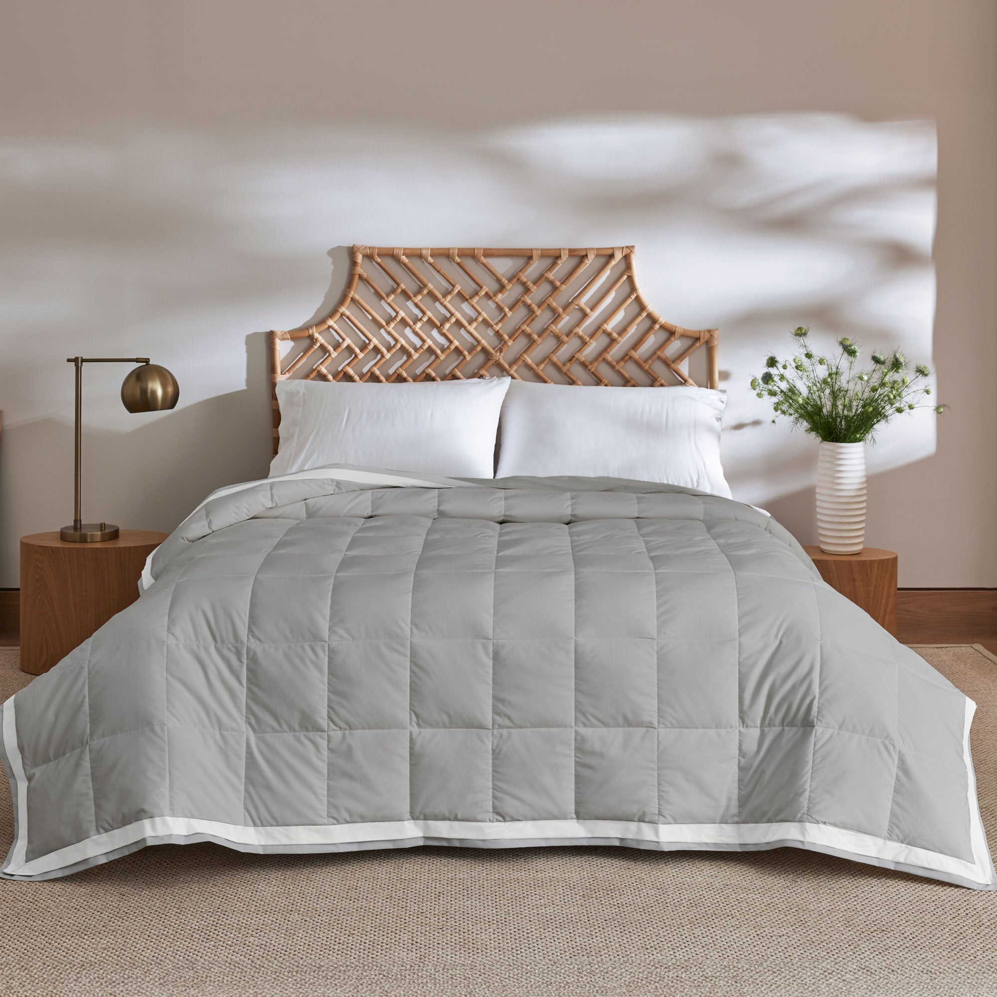 The summer cooling blanket is covered in the somber hues of gray with a complementing white trim. Bring refreshing sophistication to your personal space with this down duvet insert in gray.