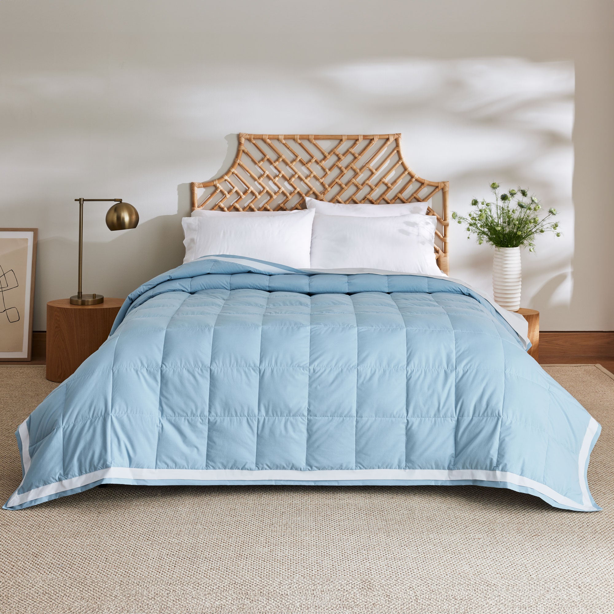 The feather down comforter blanket is enveloped in the airy tones of sky blue with a contrasting white trim. Enhance your bedding with the beauty of the skies with this summer season comforter in sky blue.