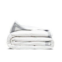 The twin down blanket is brushed in the soft tones of cloud white with a contrasting deep grey trim. Add a touch of elegance to your bedding with this cool blanket for summer in white.