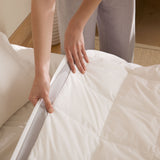 The twin down blanket is brushed in the soft tones of cloud white with a contrasting deep grey trim. Add a touch of elegance to your bedding with this cool blanket for summer in white.