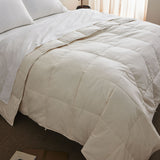 The down feather comforter is covered in solid colors of soft beige or hues of off-white that give it a crisp appearance. Bring natural light to your bedding space and turn it into a cozy spot, while you enjoy the natural feeling of cottony softness with this off white feather comforter.