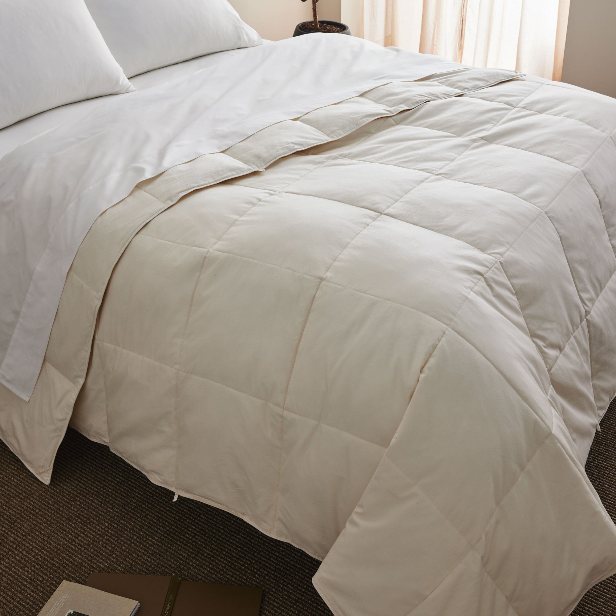 The down feather comforter is covered in solid colors of soft beige or hues of off-white that give it a crisp appearance. Bring natural light to your bedding space and turn it into a cozy spot, while you enjoy the natural feeling of cottony softness with this off white feather comforter.