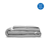 Folded Ultra Lightweight Cooling Down Comforter in gray with a small blue Real Simple Smart Sleep Awards 2024 badge in the top right corner.